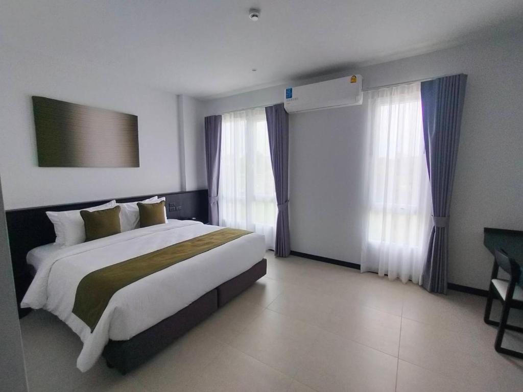 Postel nebo postele na pokoji v ubytování Hotel Whitt Hua Hin