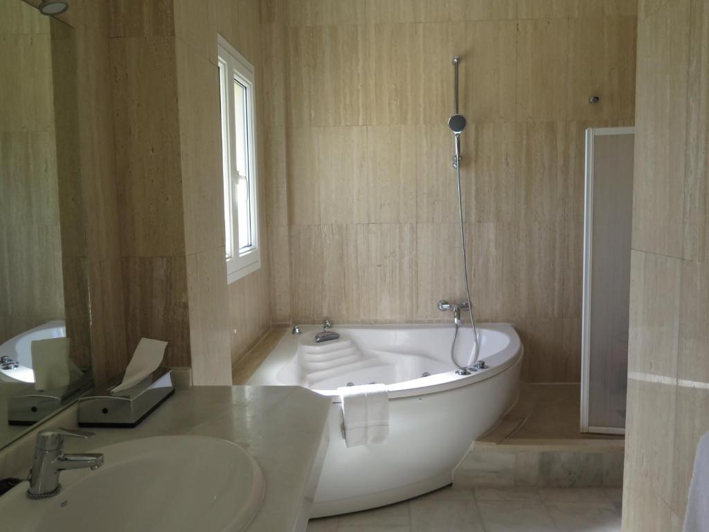 a white bath tub in a bathroom with a sink at La Luna Blanca in Torremolinos