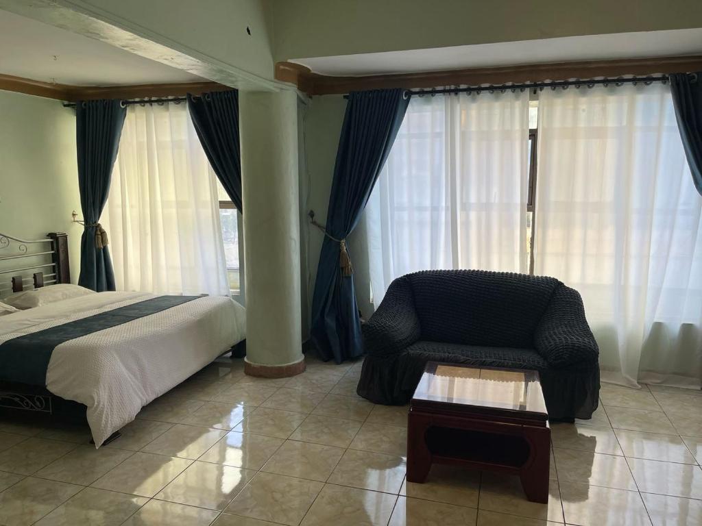 Postel nebo postele na pokoji v ubytování EXCELLENT HOTEL KAMPAlA