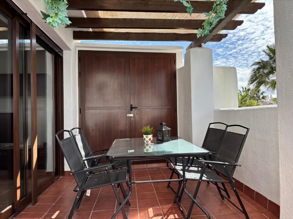 a table and chairs on a patio with a door at Salinalux Vera Playa in Vera
