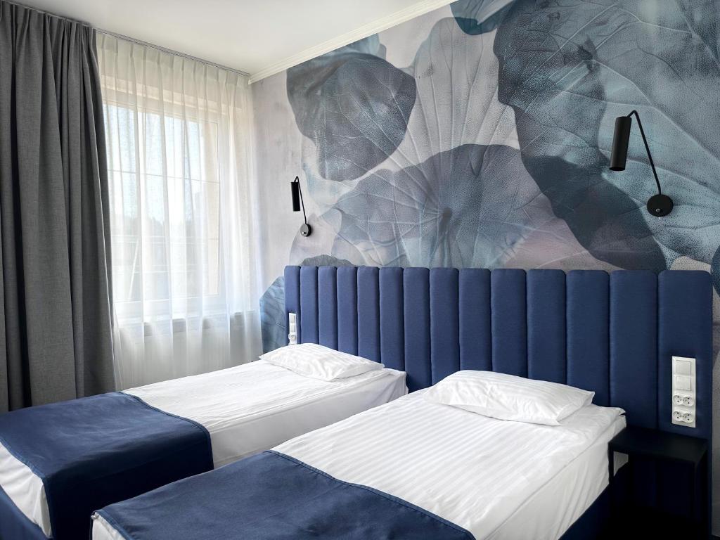 Posteľ alebo postele v izbe v ubytovaní Hotel Szydłowski