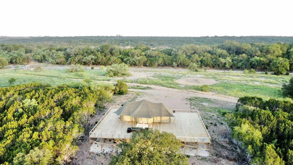 an aerial view of a tent in a field at Rest and Recharge at this Wonderful Glamping Destination in Burnet, Texas in Marble Falls