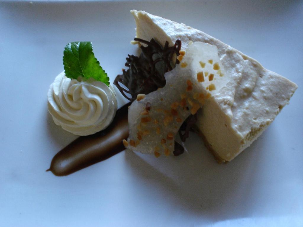 a white plate with two different types of desserts at Argosy Motor Inn in Devonport