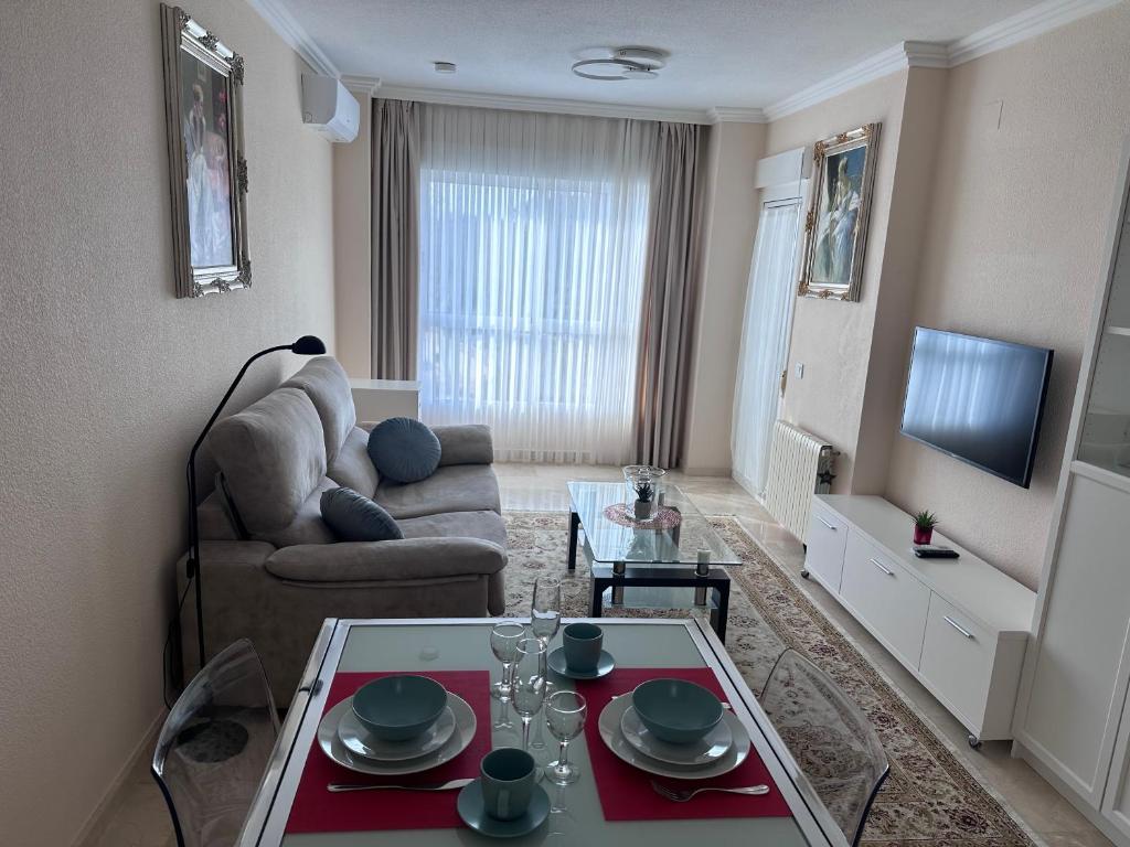 a living room with a couch and a table at Playa Albir Apartments in Albir