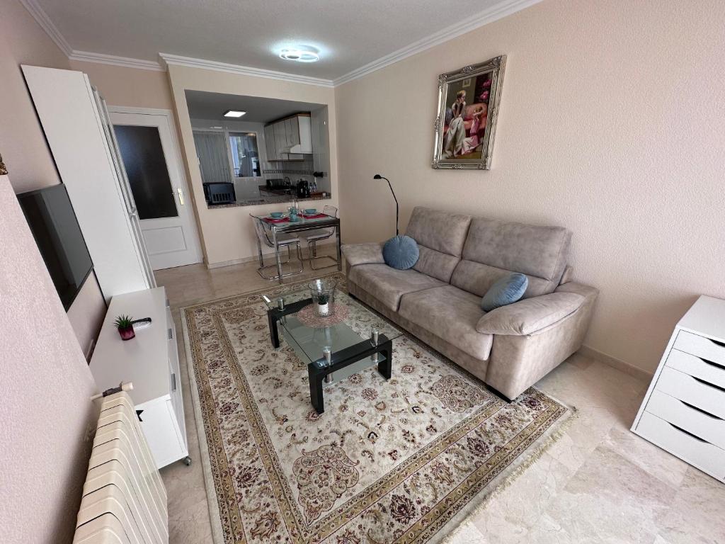 a living room with a couch and a table at Playa Albir Apartments in Albir
