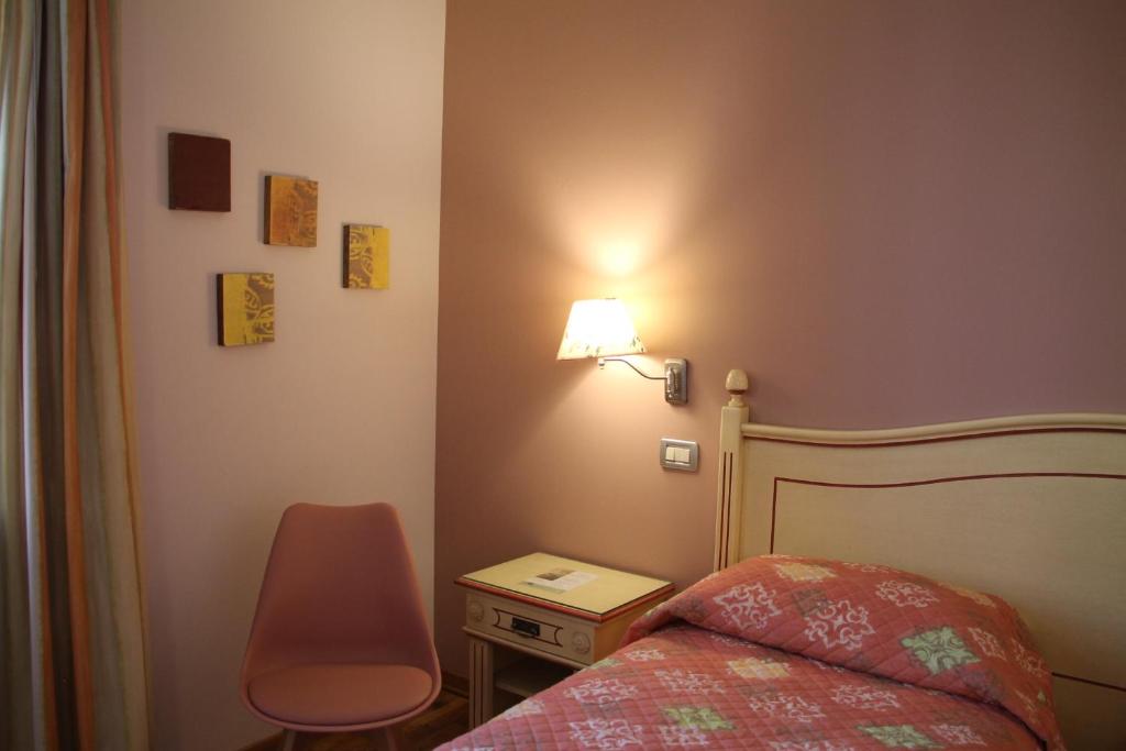 Postel nebo postele na pokoji v ubytování Hotel Matteotti