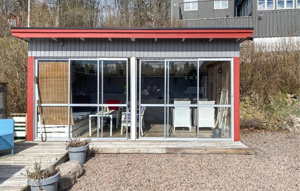 a screened in porch with a table and chairs at 1 Bedroom Stunning Home In Mullsjö in Mullsjö