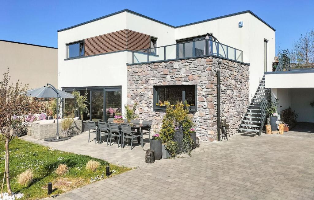 a house with a patio with a table and chairs at 1 Bedroom Lovely Apartment In Visé in Visé