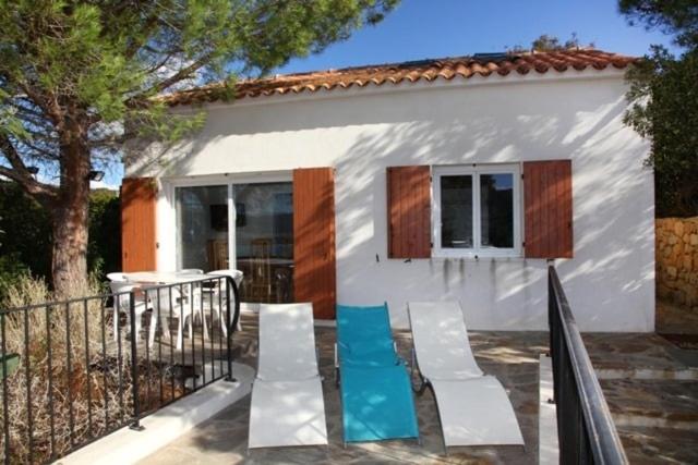 une petite maison blanche avec une table et des chaises dans l'établissement Minivilla Figari vue mer, plage Santa Giulia, à Porto-Vecchio
