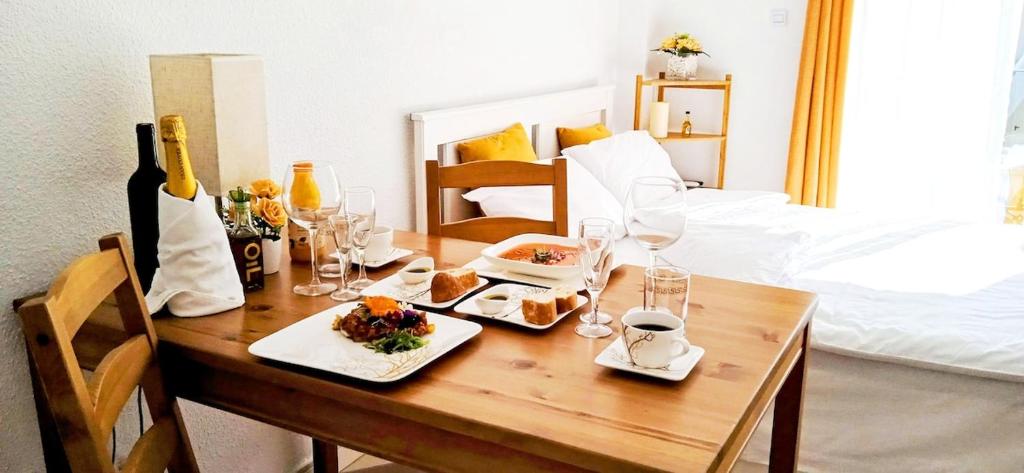 a table with food and wine glasses and a bed at The Seven Seas in Benalmádena