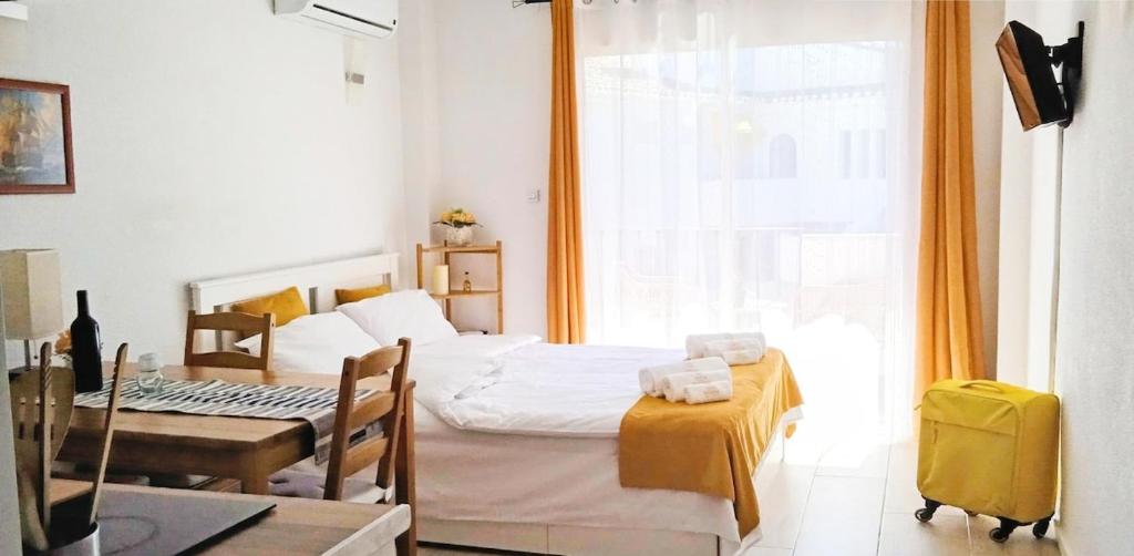 a bedroom with a bed and a desk and a window at The Seven Seas in Benalmádena