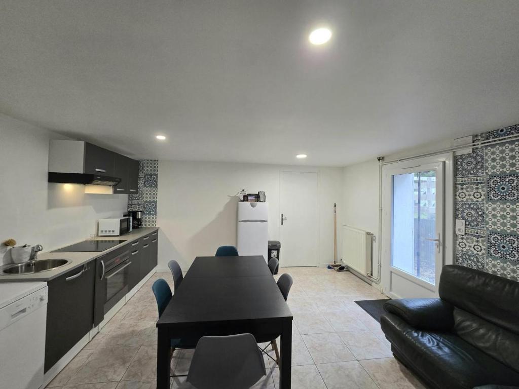 a kitchen and living room with a table and chairs at Les demoiselles de grignols in Grignols Dordogne