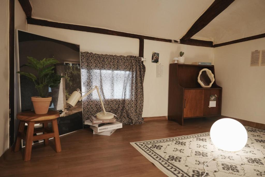 a living room with a table and a window at Licensed Private hanok with Courtyard for 7, 10 min to metro in Busan