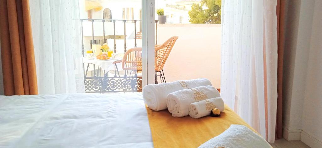 a bedroom with a bed with towels on a table at The Seven Seas in Benalmádena