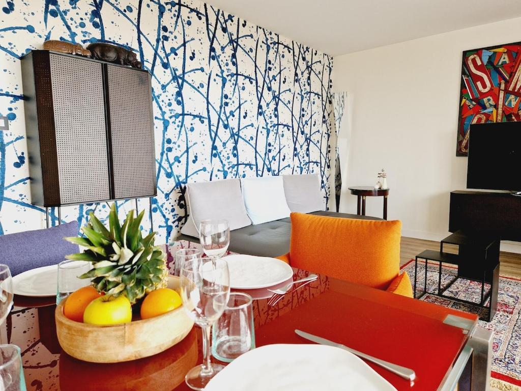 - une salle à manger avec une table et des fruits dans l'établissement L'Orée - Bel appartement balcon vue mer et parking, à Les Sables-dʼOlonne