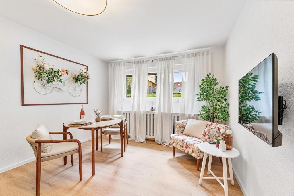 a living room with a table and a couch at Black Forest Flower Apartment in Bad Wildbad