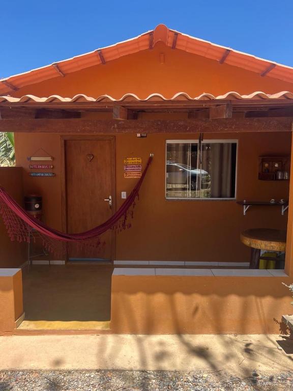 a house with an orange roof and a window at viladasararas in Alto Paraíso de Goiás