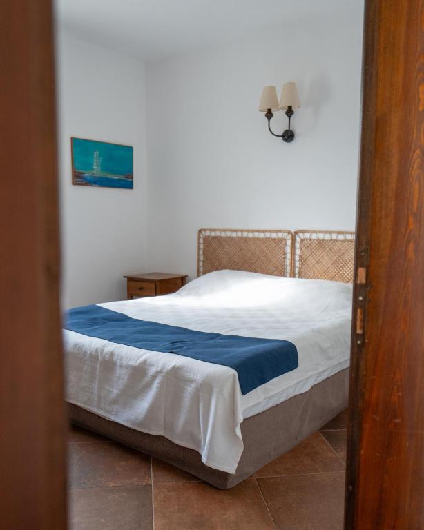 a bedroom with a bed with a blue blanket at Casa Caria Suites in Bodrum City