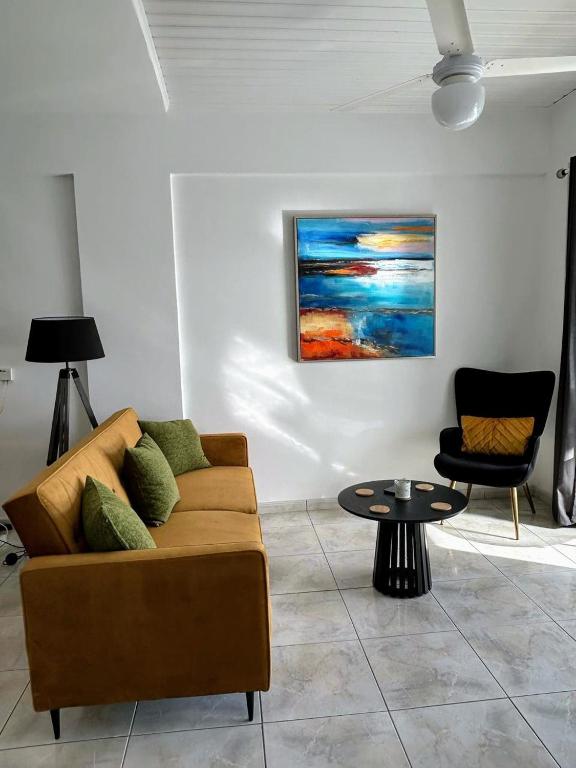 a living room with a couch and a table at Casa Sea Breeze in Larnaca
