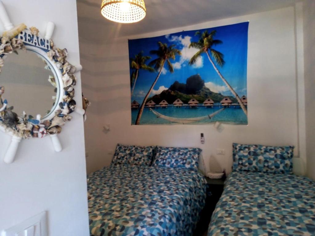 a bedroom with a bed and a mirror at La perla di Maria in Grado