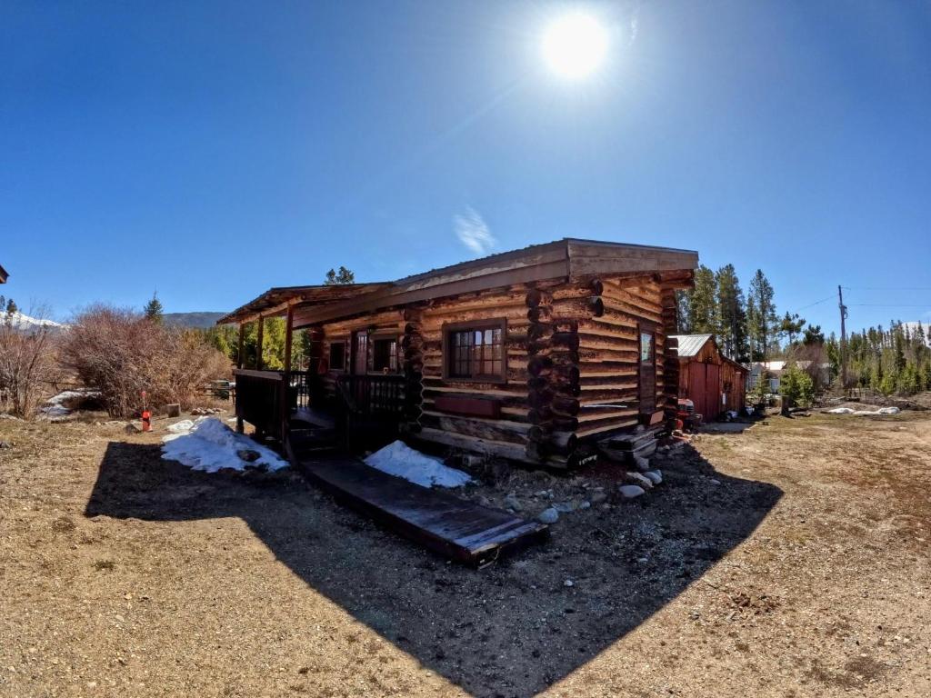 a log cabin with a slide in a field at Arrowhead in Grand Lake