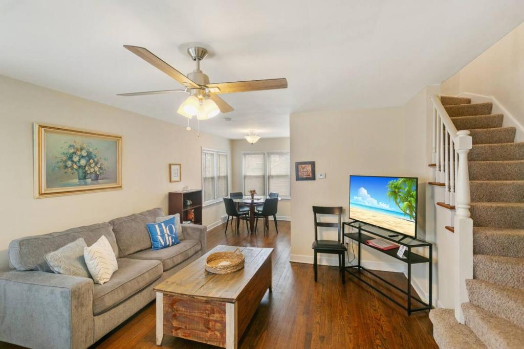 a living room with a couch and a table at Downtown Libertyville Duplex Near Naval Base in Libertyville