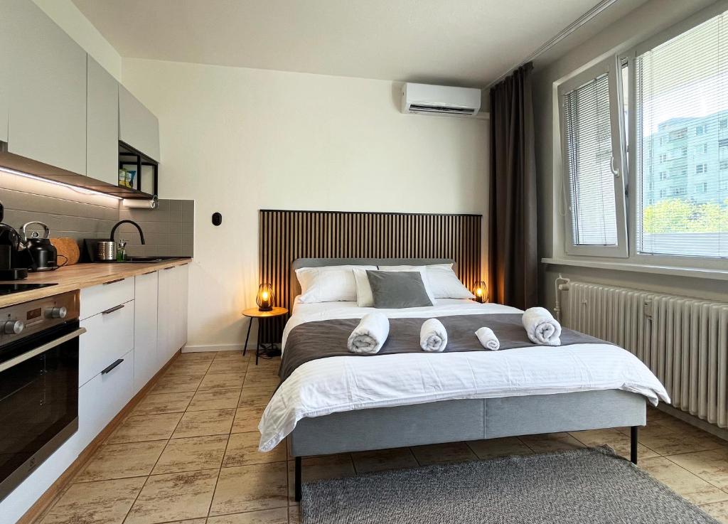 a bedroom with a large bed with towels on it at New cozy studio, AC & Balcony in Bratislava