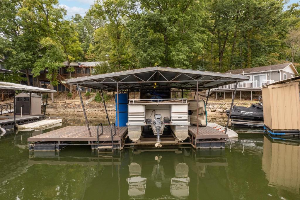 a house on a dock on a body of water at LOTO BREEZE 2 in Sunrise Beach