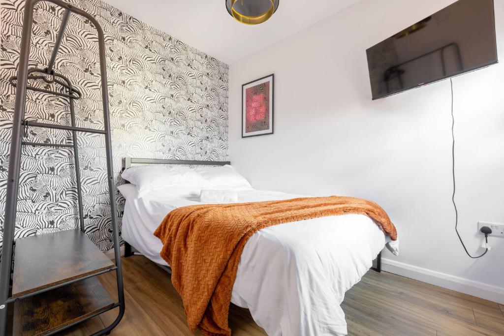 a bedroom with a metal bed with a blanket on it at Bliss Stay Belfast The Mount in Belfast