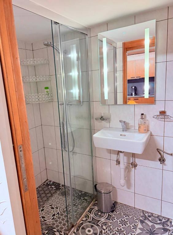 a bathroom with a sink and a shower at Vintage Apartment By Apartments Capricorn in Gsteigwiler