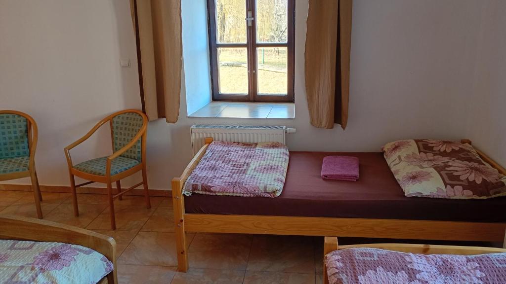 Postel nebo postele na pokoji v ubytování Penzion Zámek Drahonice