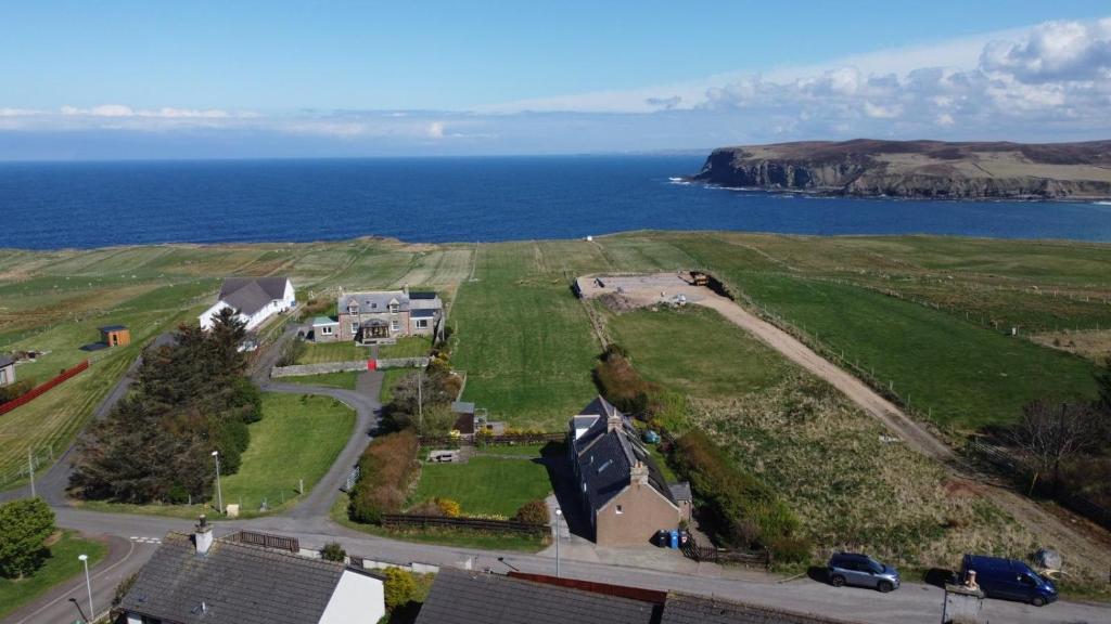 eine Luftaufnahme eines Hauses und des Ozeans in der Unterkunft Traditional 2 bed croft in Portskerra
