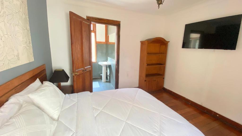 Postel nebo postele na pokoji v ubytování Cozy Place Hostal