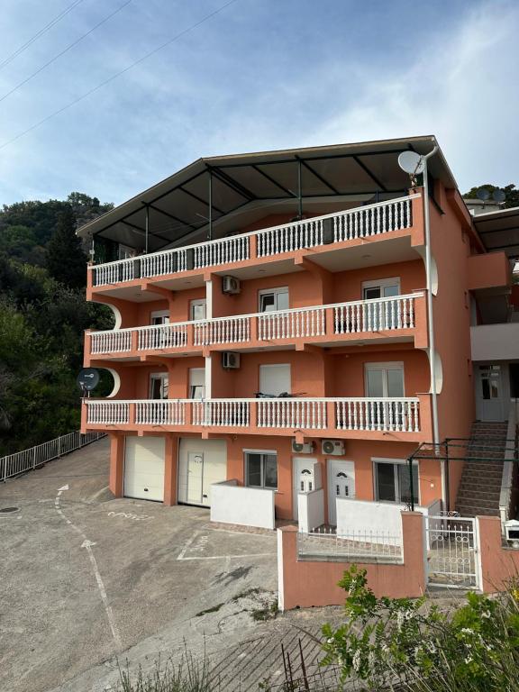 a large orange building with a lot of garage at Benelux Šušanj in Bar
