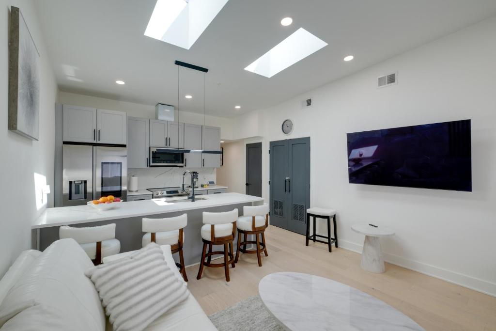 a kitchen and living room with a couch and a table at 4 Mi to Smithsonian Museums Modern DC Condo! in Washington