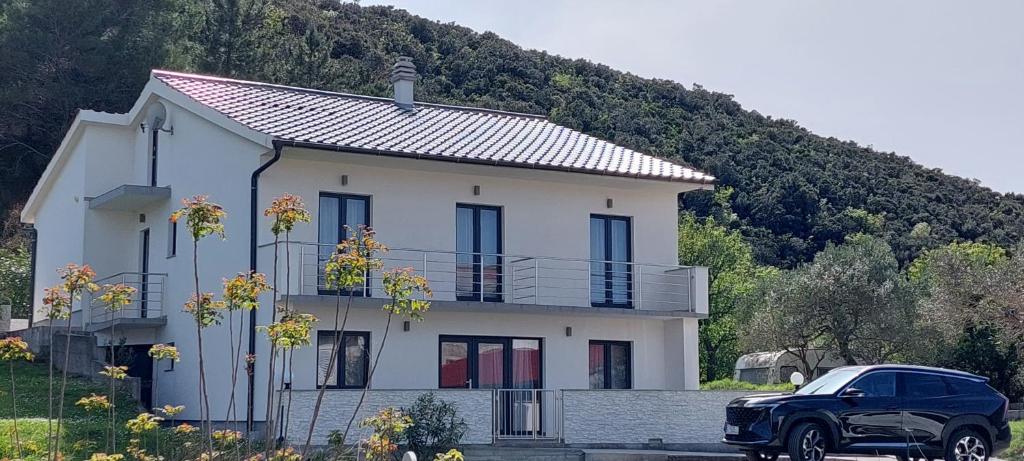 Ein schwarzer Truck parkt vor einem Haus. in der Unterkunft Holiday apartments Cecilija in Supetarska Draga