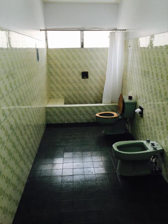 a bathroom with two toilets and a sink at Palmira Hostel in Tegucigalpa