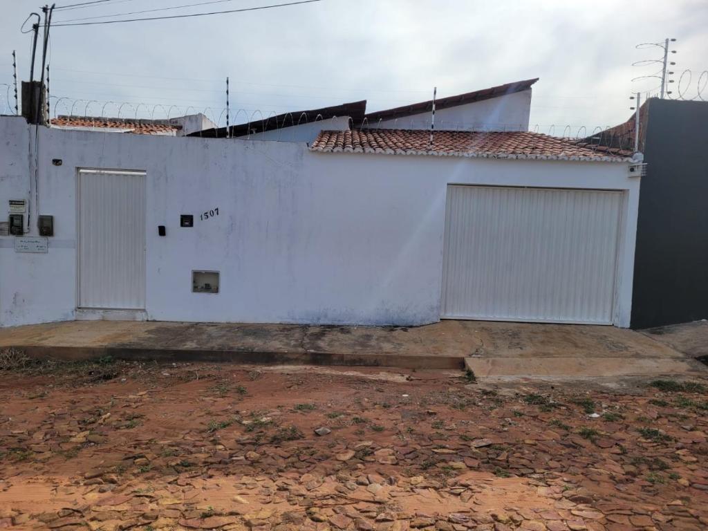 a white building with two doors on the side of it at Juazeiro do Norte CE Sao Jose in Juazeiro do Norte