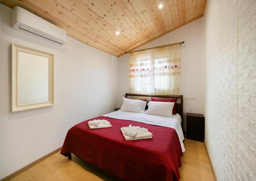 a bedroom with a bed with two towels on it at The Woodnest in Vonitsa