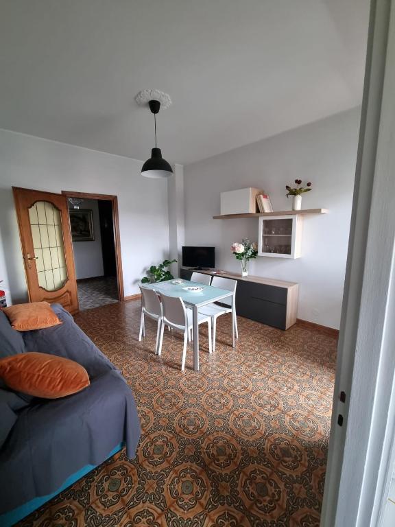 a living room with a table and a couch at A Casa di Simo in Turin