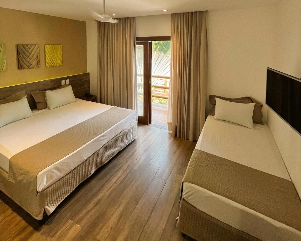 Postel nebo postele na pokoji v ubytování Ravenala Hotel
