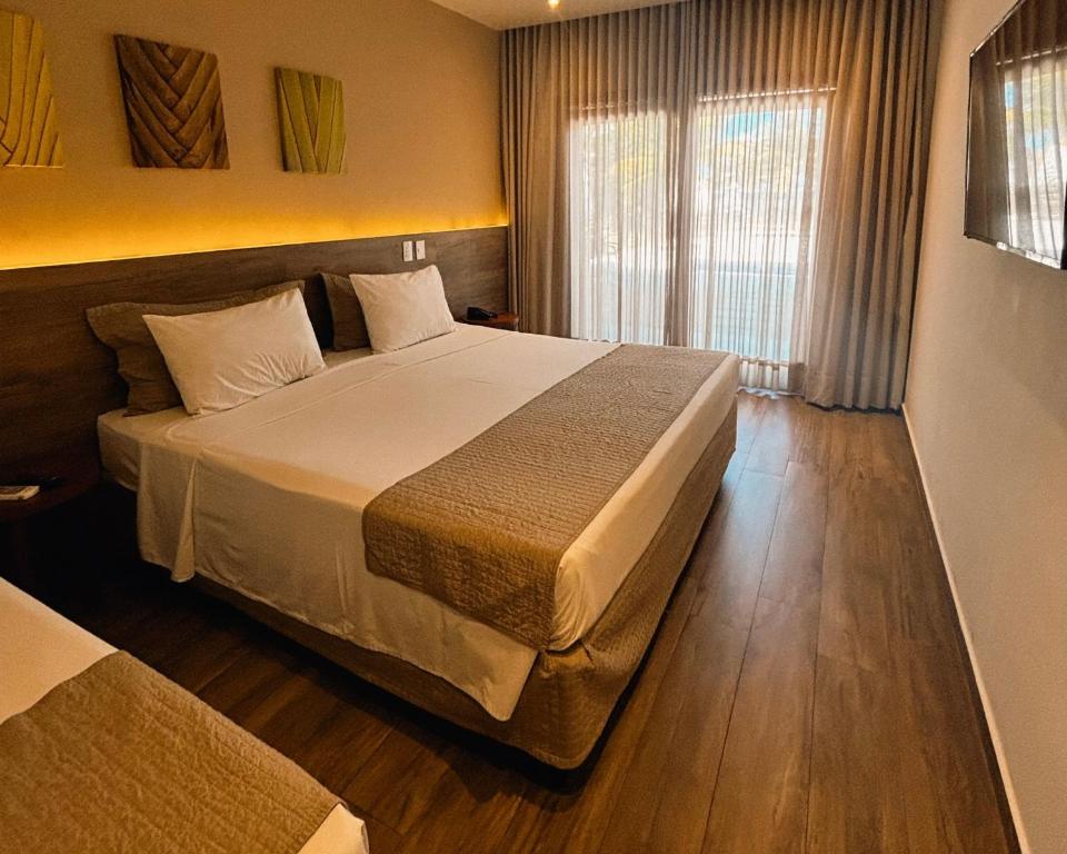 Postel nebo postele na pokoji v ubytování Ravenala Hotel