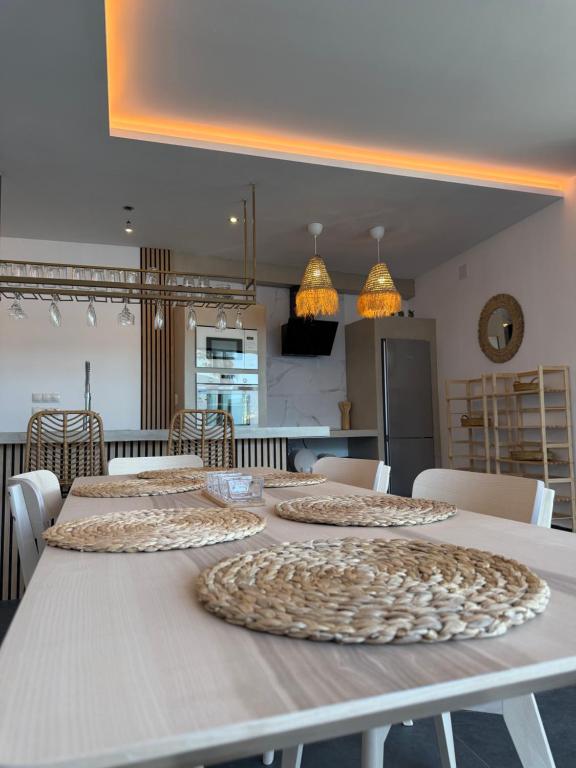 a white table with four plates on top of it at Villa Maréa in Algeciras