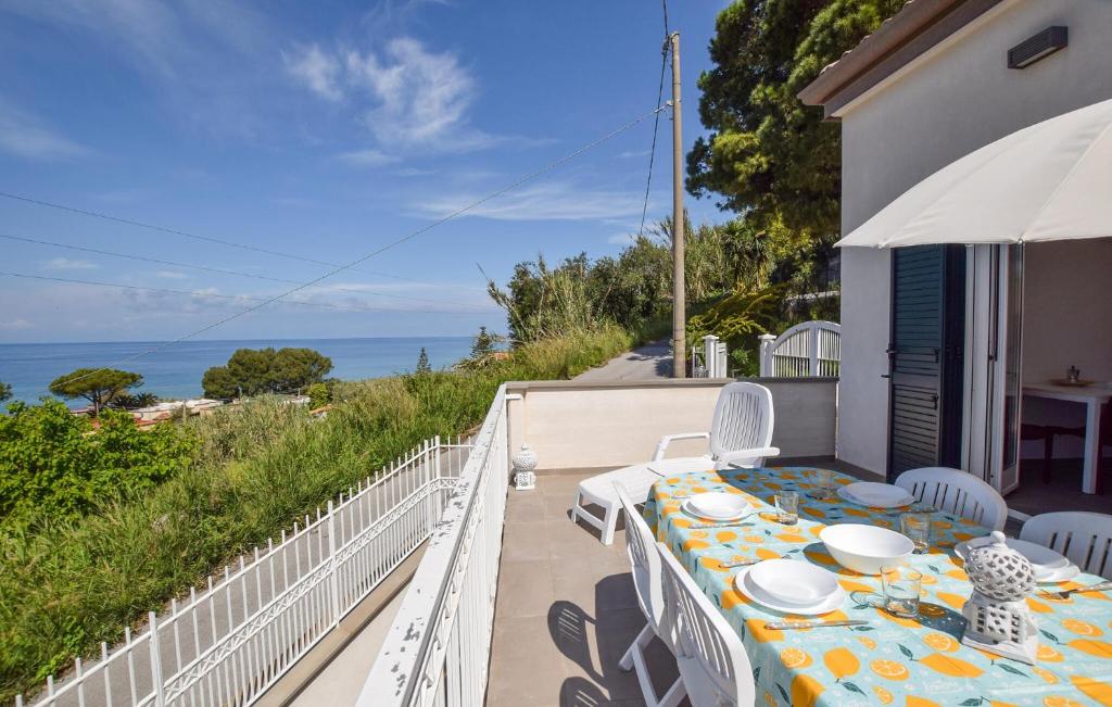 a table on a balcony with a view of the ocean at 1 Bedroom Gorgeous Home In Castellabate in Castellabate
