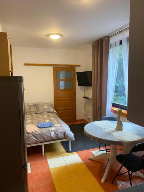 a bedroom with a bed and a table in it at Arkuszowa 58 Studio 15 in Warsaw