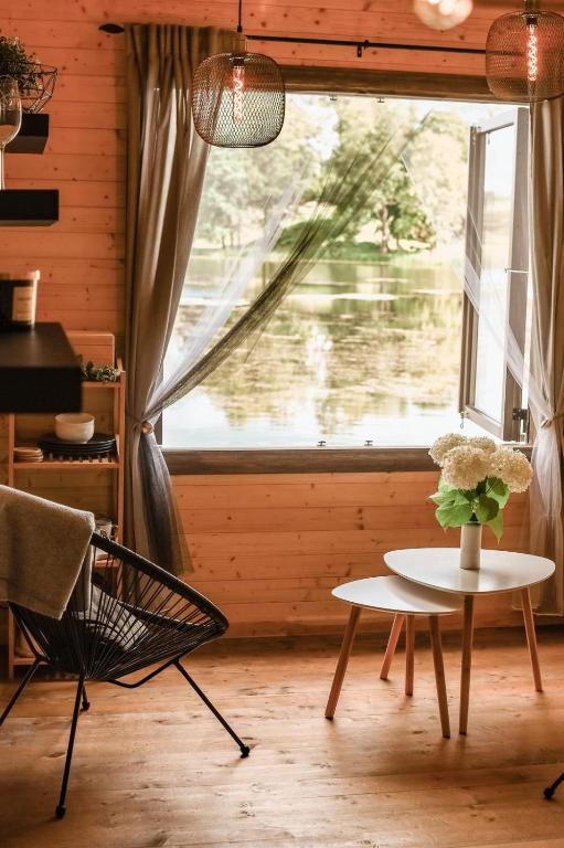 a room with a table and a chair and a window at Mr.Banga in Alūksne