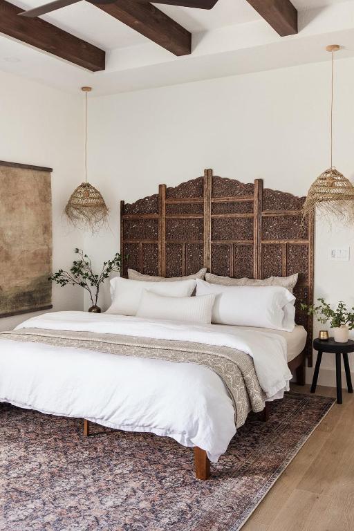a bedroom with a large bed with a wooden headboard at Westminster moroc style in London
