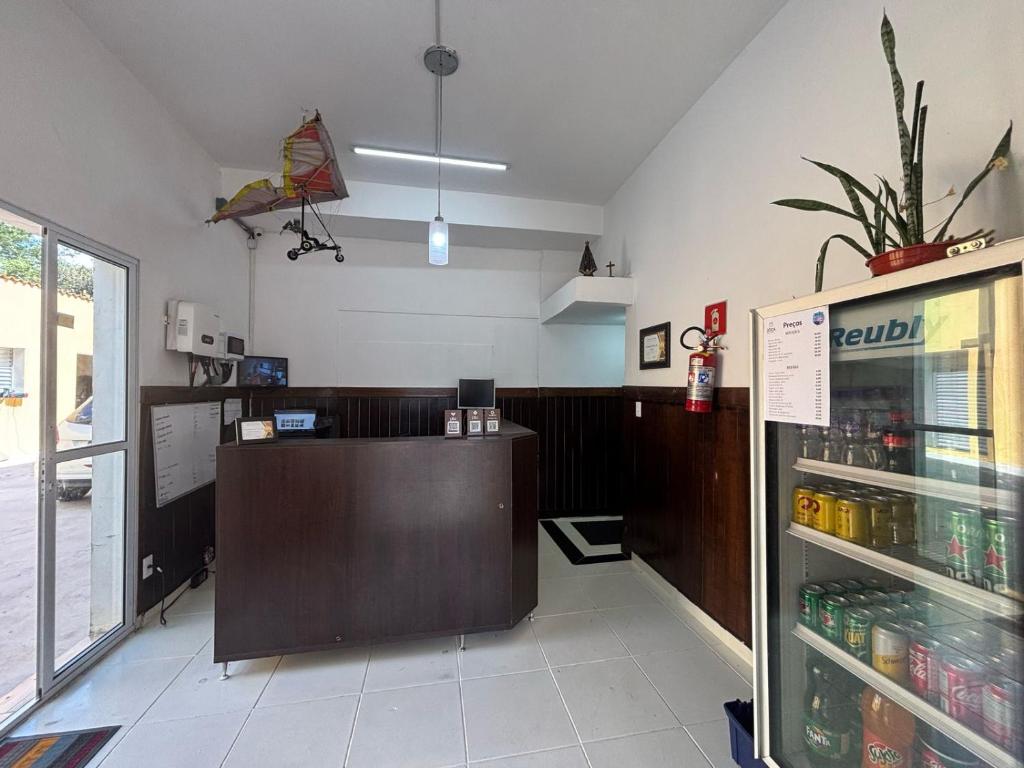 a fast food restaurant with a counter and a refrigerator at Pousada São Luiz in Bragança Paulista