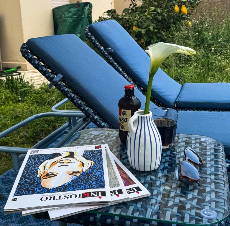 a table with a book and a vase with a flower at La Casa Blu Rimini in Rimini