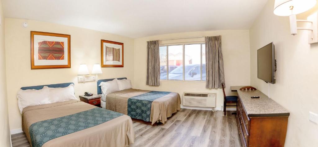 Postel nebo postele na pokoji v ubytování Central Phoenix Hotel